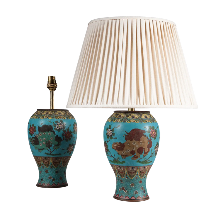 Pair of Chinese Cloissoné Lamps with foo dog designs in green and brown on a blue floral enamel ground circa 1870.