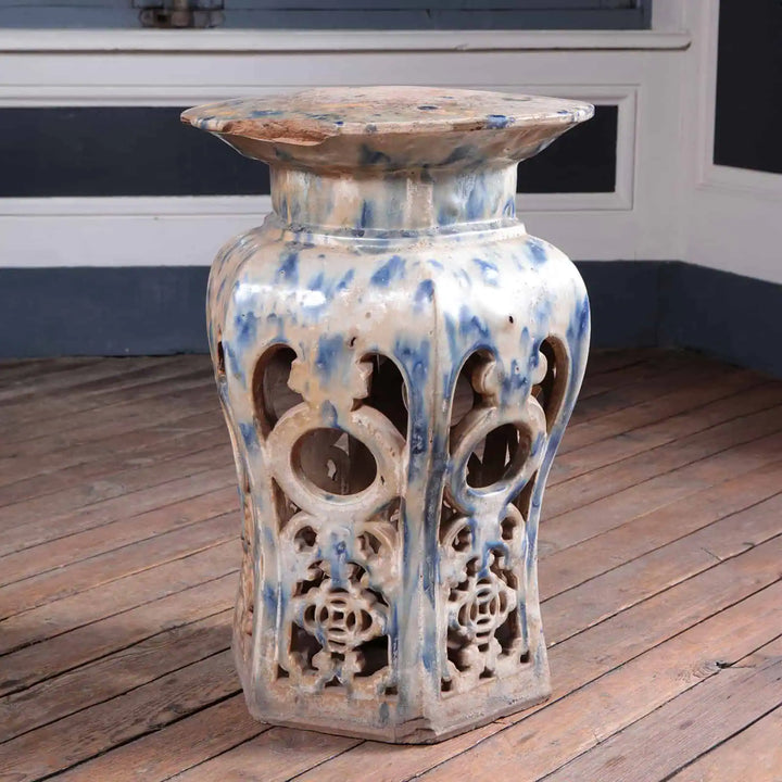 Antique Chinese drip glazed ceramic stool with openwork design by Collection EE30 in a rustic interior setting