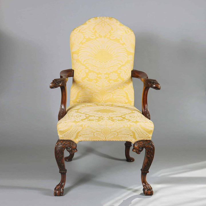 George I style walnut open armchair with yellow silk damask upholstery and carved eagle head arms by Collection CK20.
