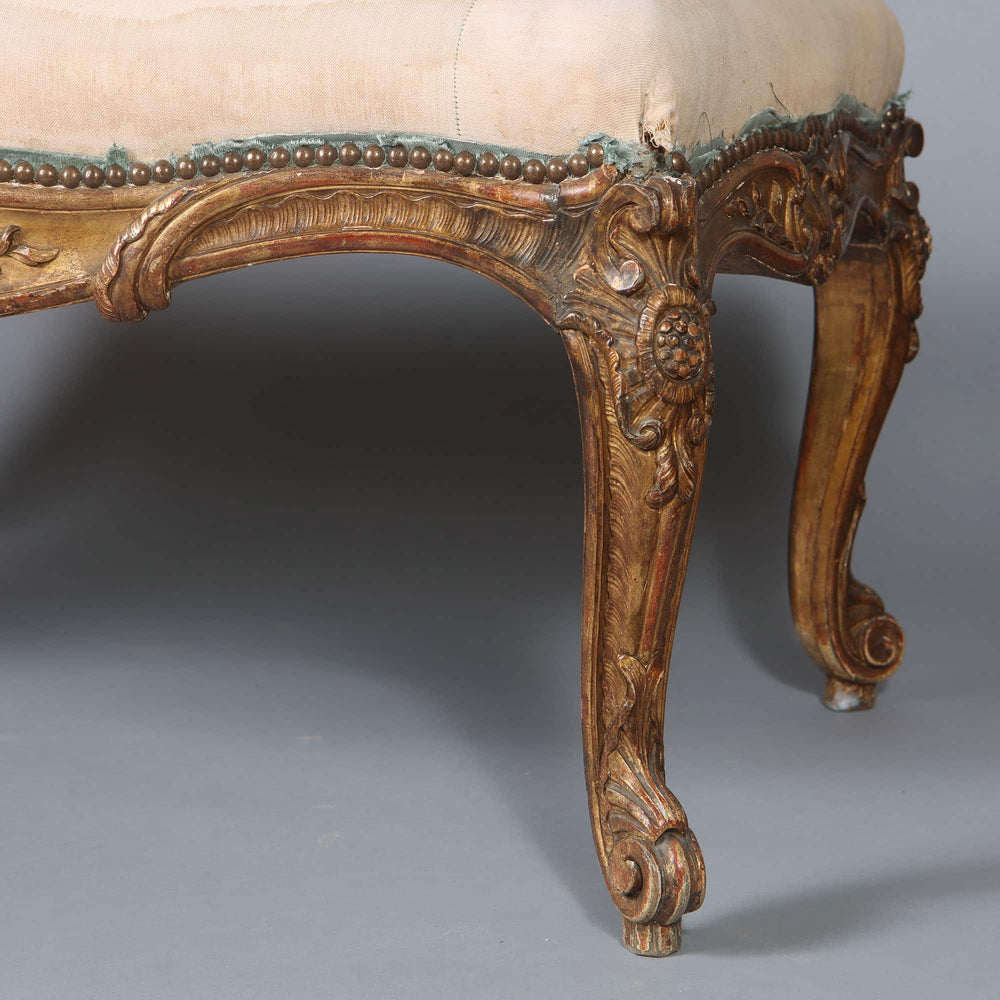 Close-up of a carved gilt beech cabriole leg on a Napoleon III Rococo window seat from Collection CK20