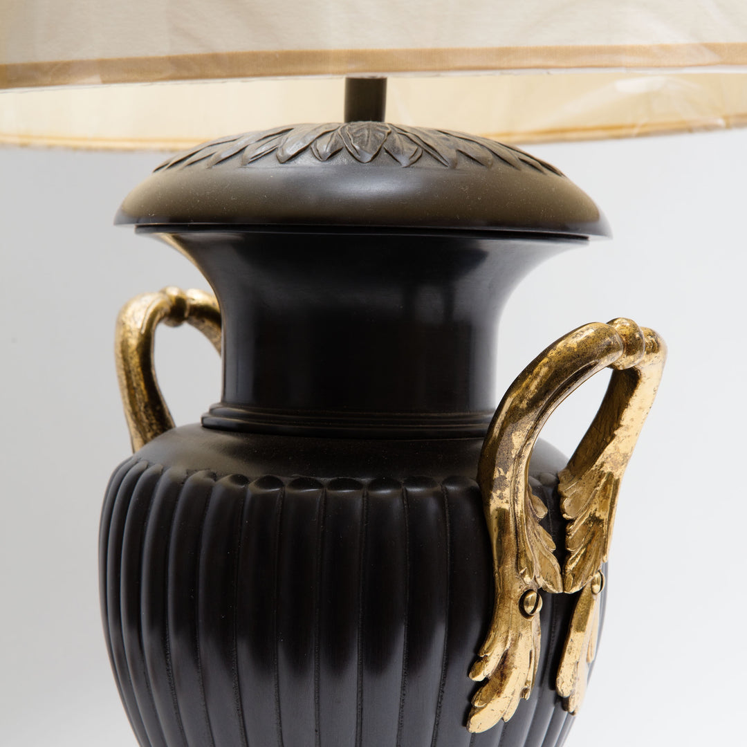 Pair of Neo-Classical Bronze Urn Lamps with leaf neck decoration, reeded body, and lacquered brass handles, circa 1970.