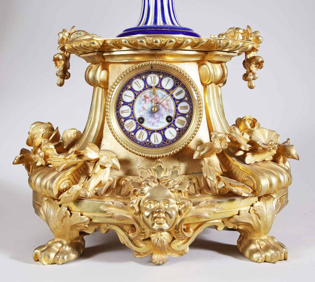 Antique Napoleon III ormolu and Sevres porcelain clock base with detailed gilded floral and face motifs by Nwtiques