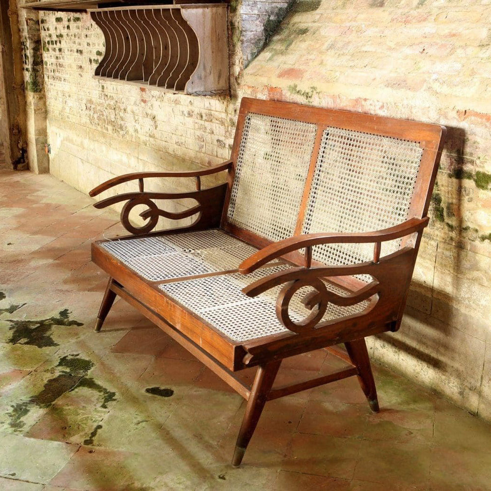 Early 20th century Bombay Art Deco settee with caned panels and Q motif arms by Collection EE20 in original condition