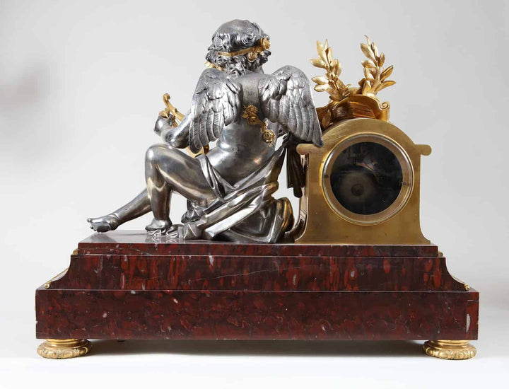 Rouge Griotte Marble French clock garniture with silvered bronze cherub, gilt detailing, sold by Nwtiques