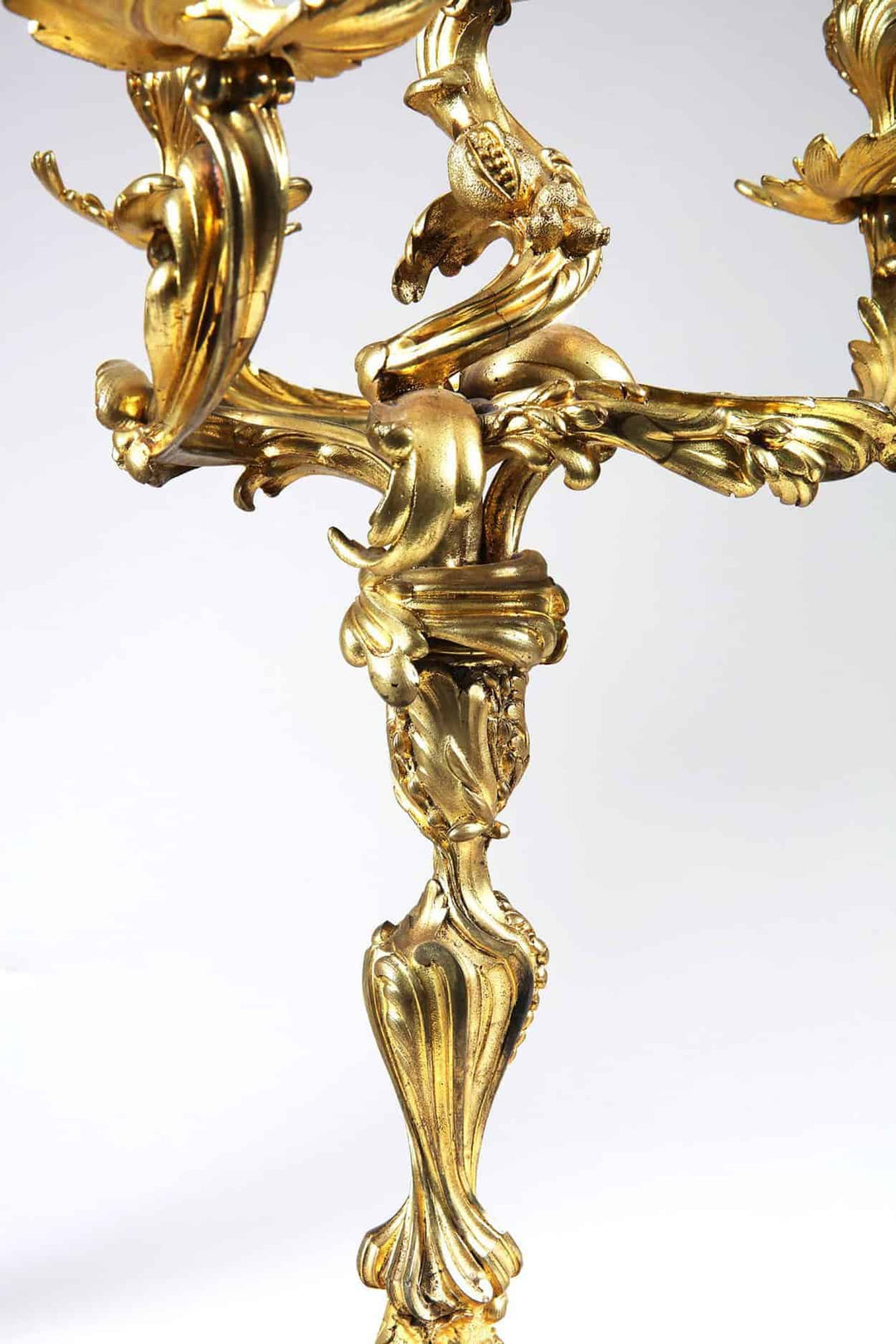 Close-up of ornate Louis XV style four-light ormolu candelabra leg detail from Collection NI10 with intricate gilded design