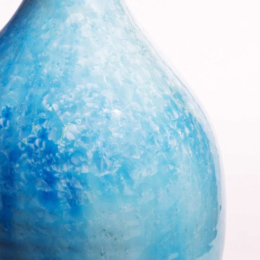 Close-up of blue crystalline glaze on a ceramic table lamp by Nwtiques showcasing detailed texture.