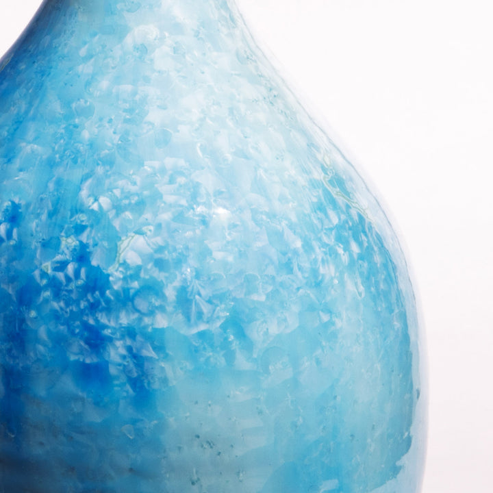 Close-up of blue crystalline glaze on a ceramic table lamp by Nwtiques showcasing detailed texture.