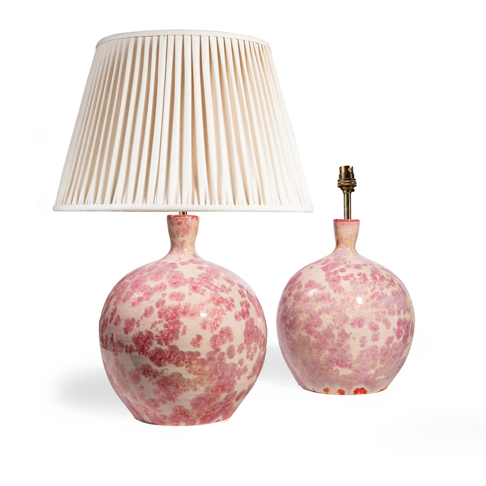 Pair of pink crystalline glazed spherical vase lamps by Nwtiques with pleated ivory lamp shade