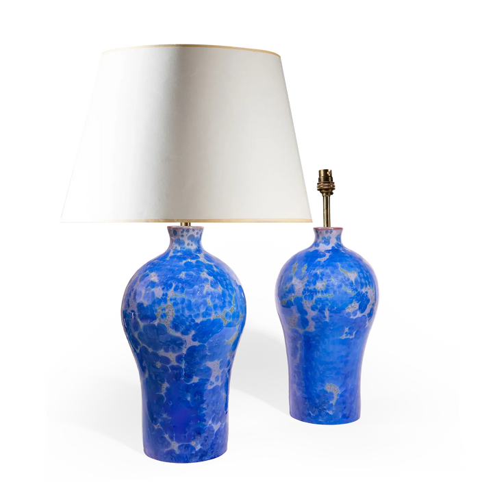 Pair of blue crystalline glazed ceramic vase lamps by Nwtiques with white shades and gold trim