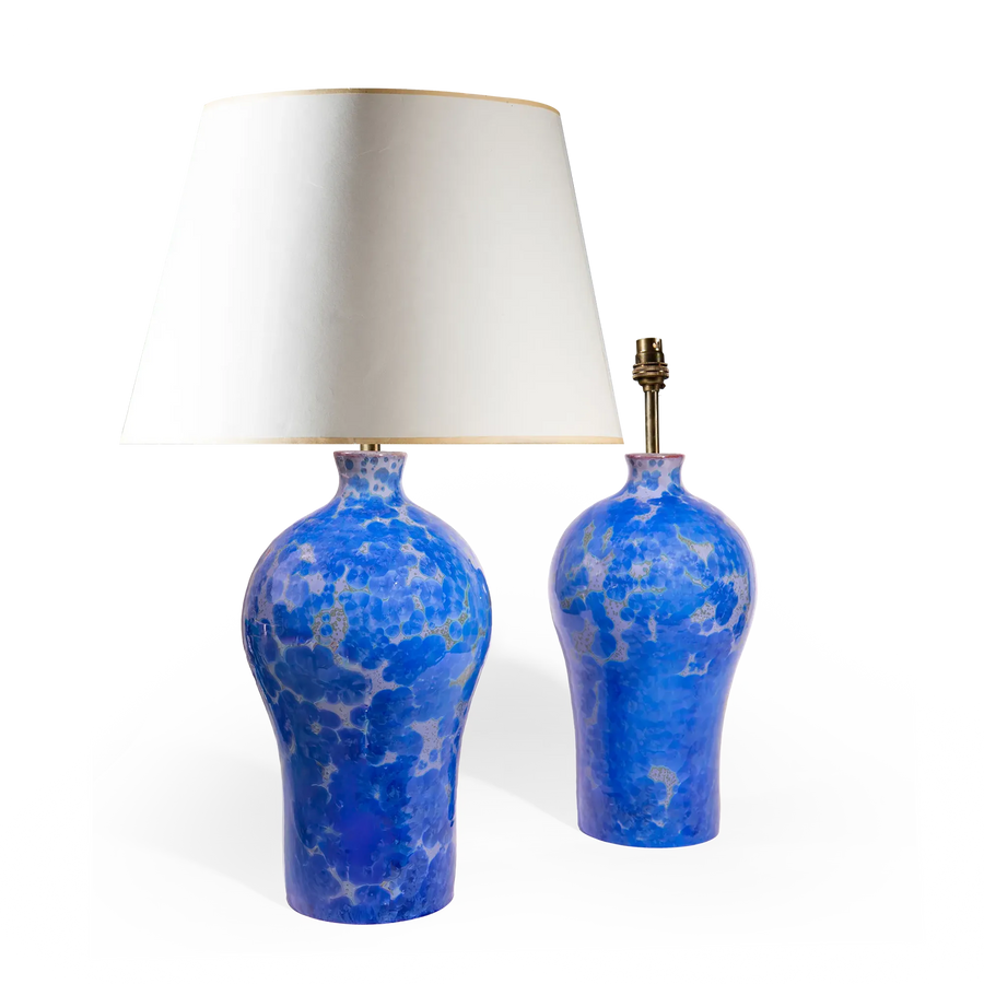 Pair of blue crystalline glazed ceramic vase lamps by Nwtiques with white shades and gold trim