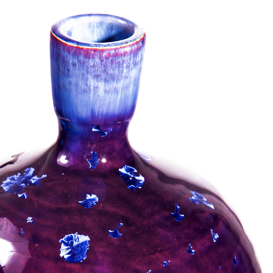 Close-up of a Nwtiques purple vase lamp with vivid blue crystalline glaze details on porcelain surface