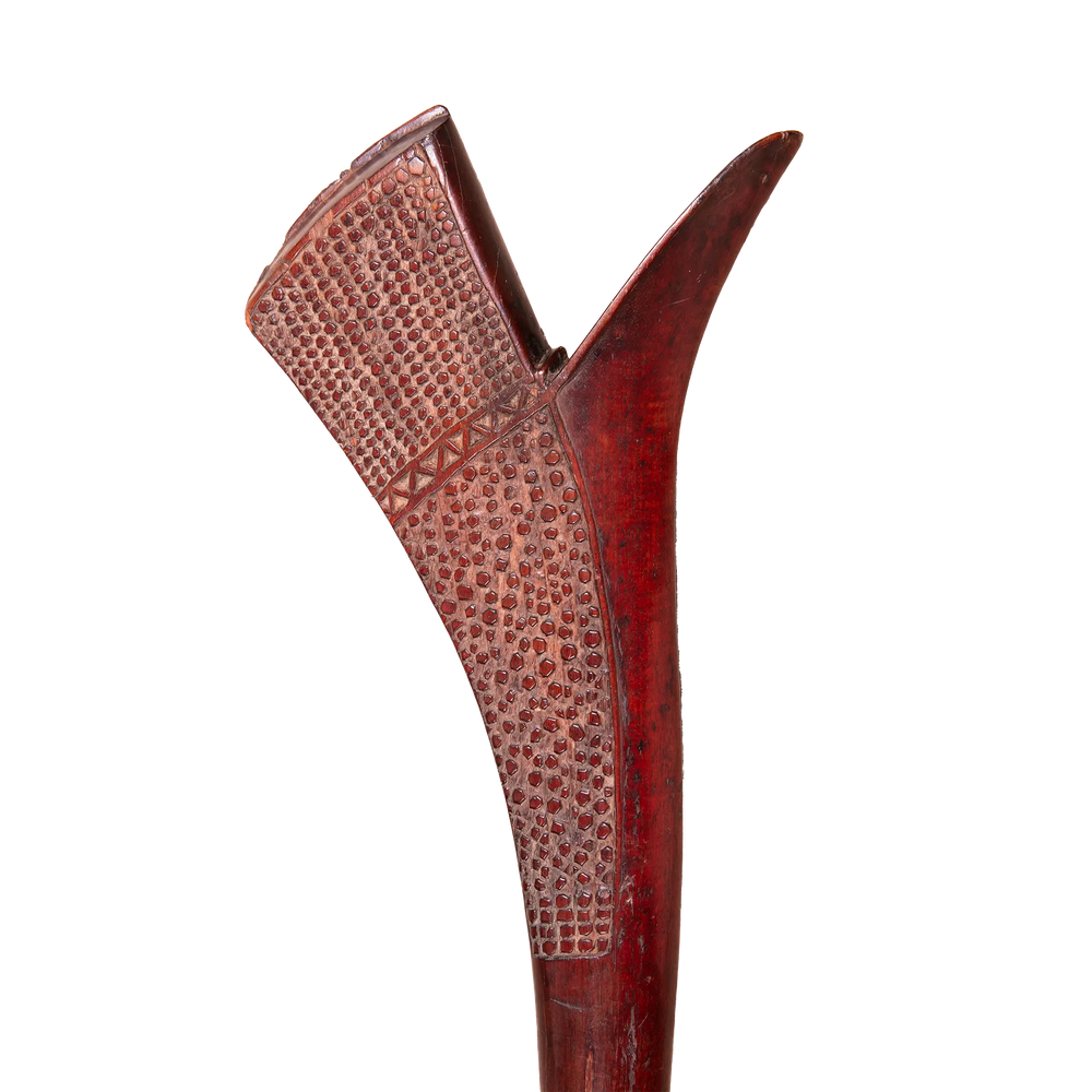 Detail of a carved Fijian Gata war club in dark hardwood from Collection ON20, showcasing intricate traditional patterns.