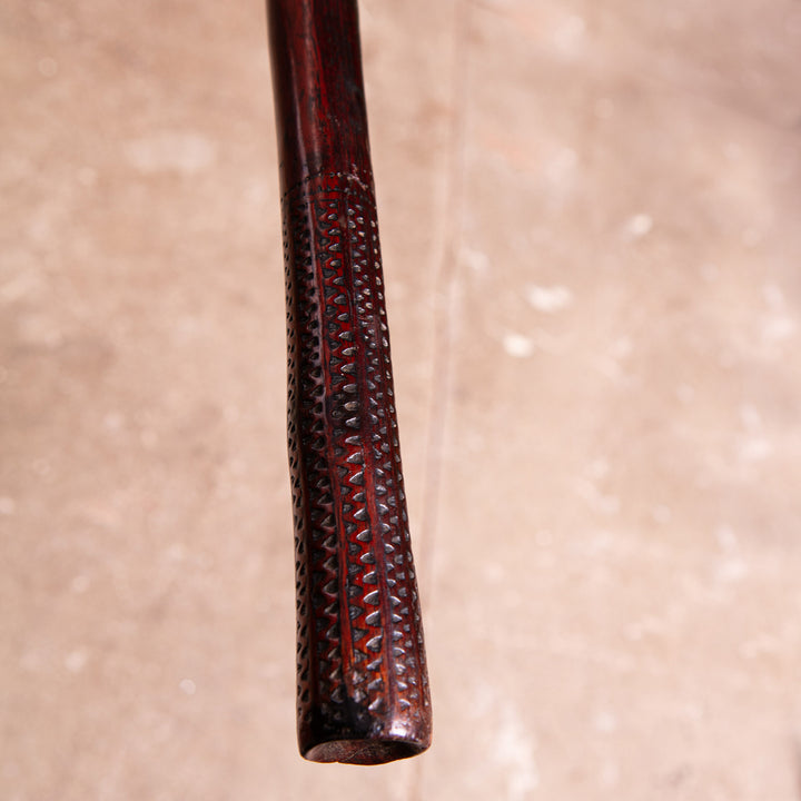 Close-up of the finely carved handle of a Fijian Ula throwing club by Nwtiques showing intricate geometric patterns
