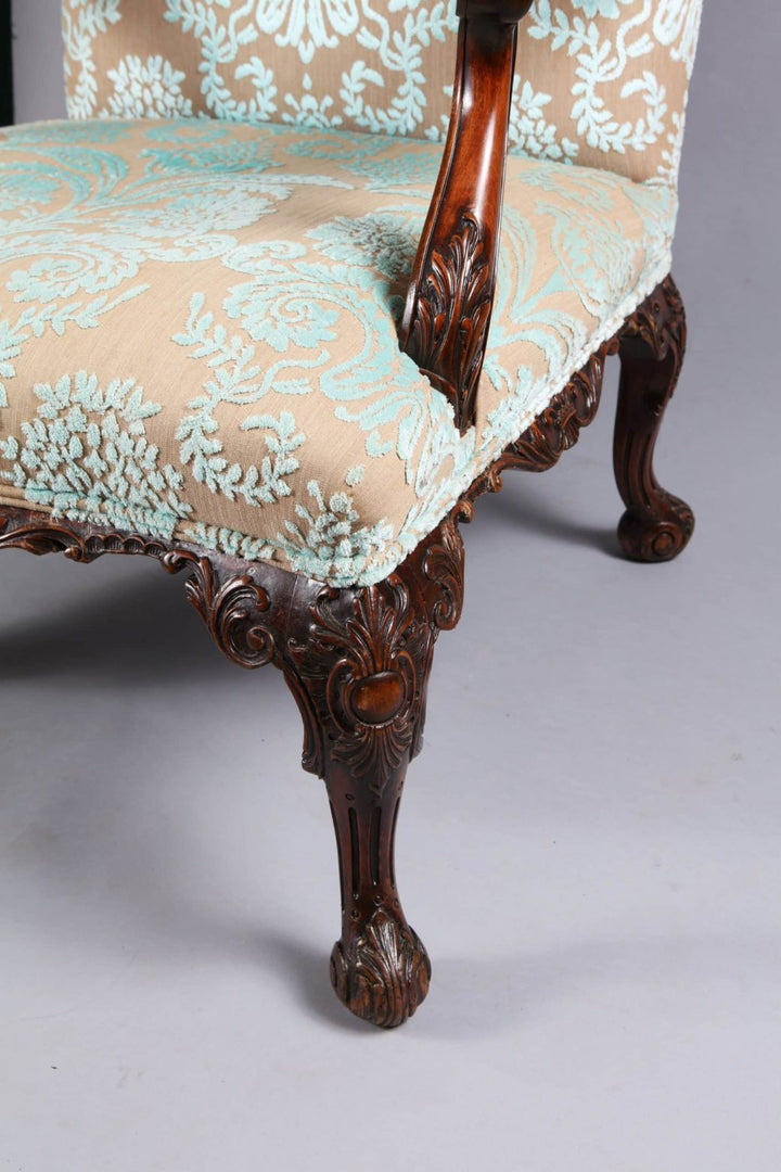 Close-up of carved wood leg and arm detail on Gainsborough chair by Collection CK20 with ornate upholstery