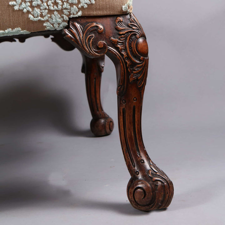 Close-up of the hand-carved wood leg on a Gainsborough chair by Collection CK20, showcasing ornate Georgian detailing.