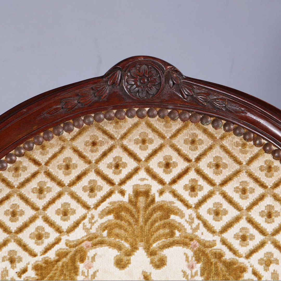 Close-up of carved mahogany backrest and patterned upholstery on George III armchair by Nwtiques