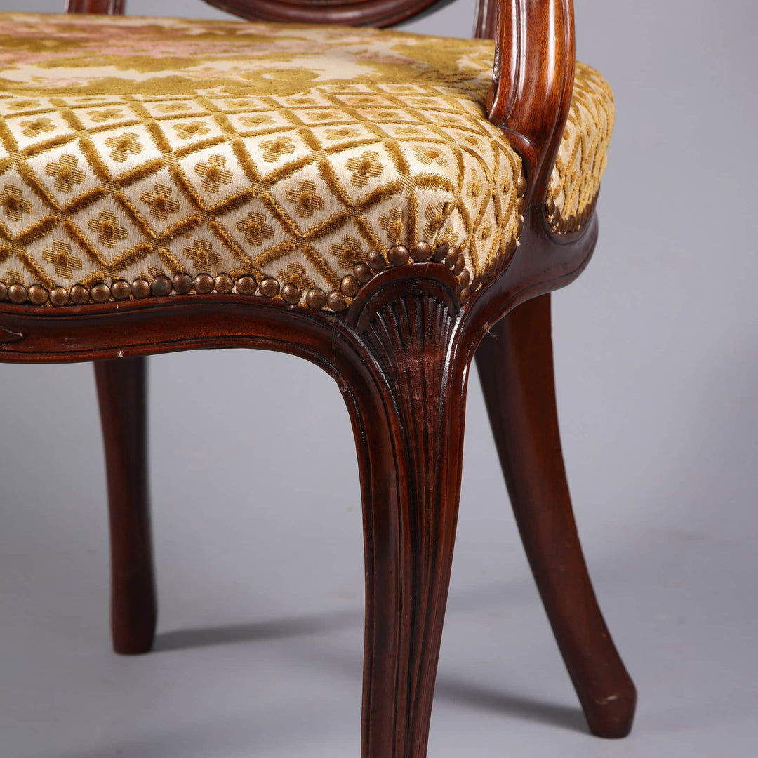 Close-up of a George III mahogany armchair leg with patterned upholstery by Nwtiques