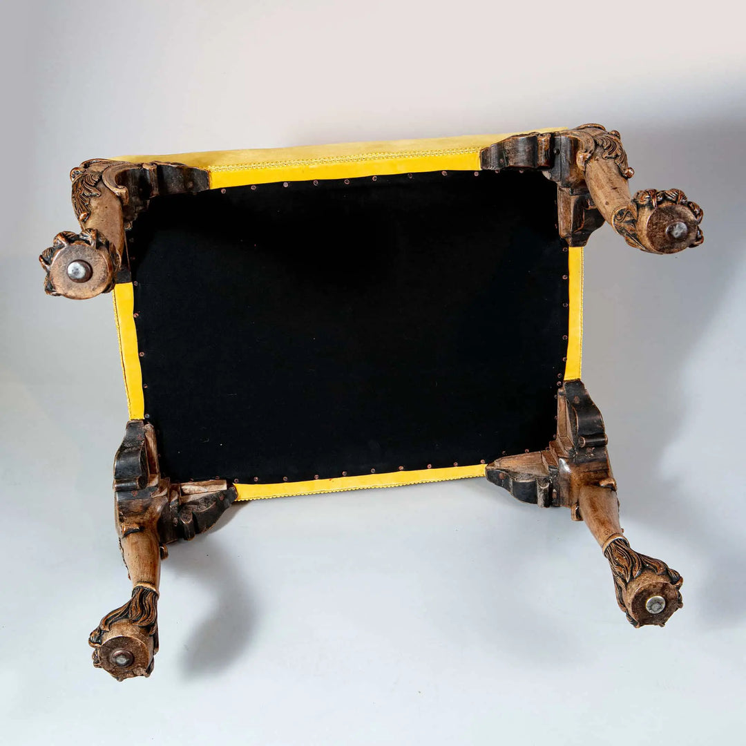 Underside view of 19th Century faded walnut George II stool with carved legs and yellow velvet, Collection CK20