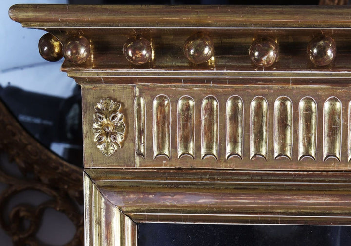 George III Three-plate Giltwood Overmantel Mirror with detailed giltwood carvings, circa 1780, England, 146x106 cm.