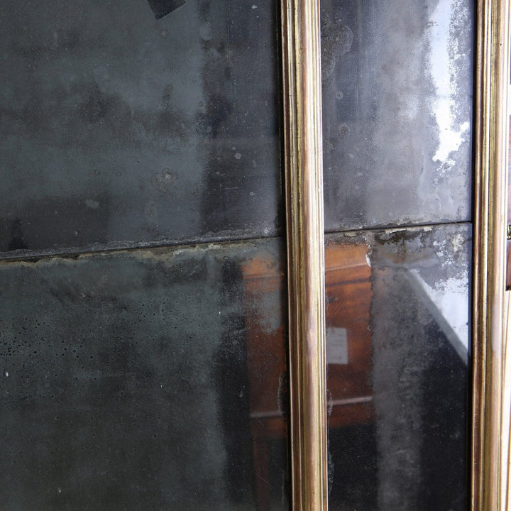 George III Three-plate Giltwood Overmantel Mirror with aged patina on reflective glass panels and giltwood frame.