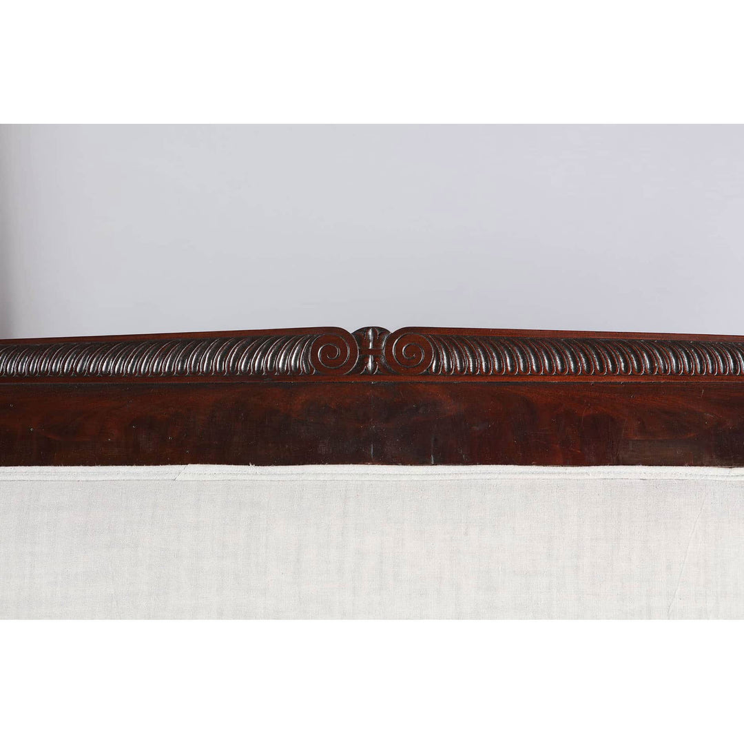 Close-up of carved mahogany backrest detail on Early 19th Century French Empire sofa by Collection TH20