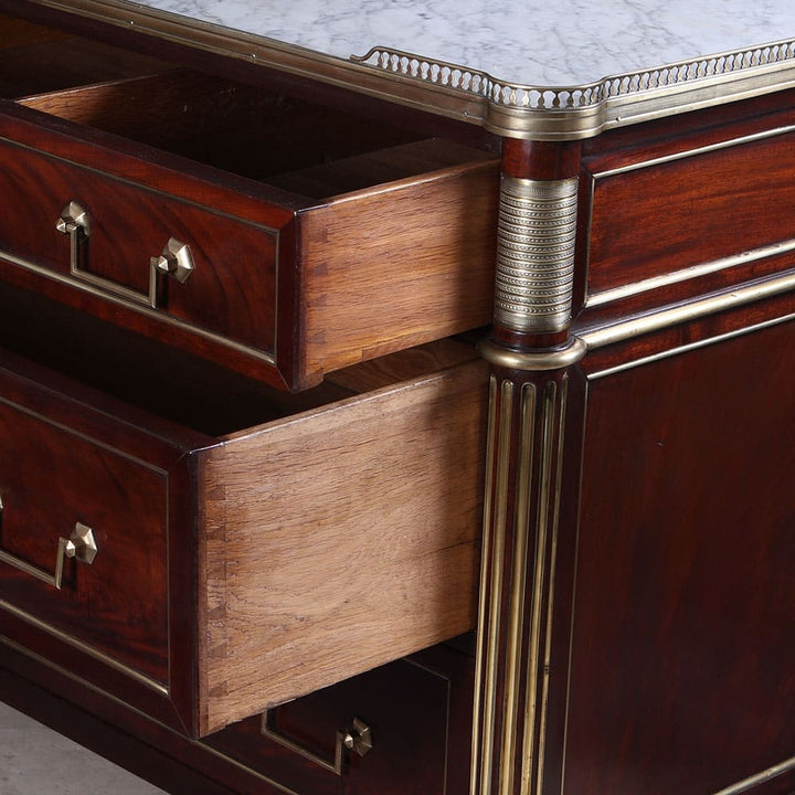 Close-up of Collection EE40 French Directoire commode with open mahogany drawers and brass detailing under Carrara marble top