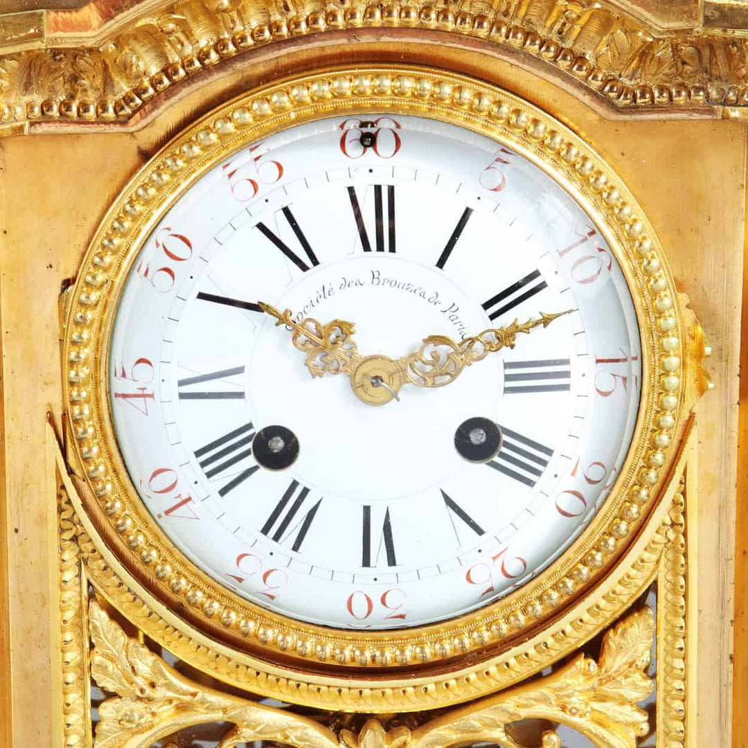 Close-up of gilt bronze antique mantel clock dial with Roman numerals by Société des Bronzes de Paris from Nwtiques