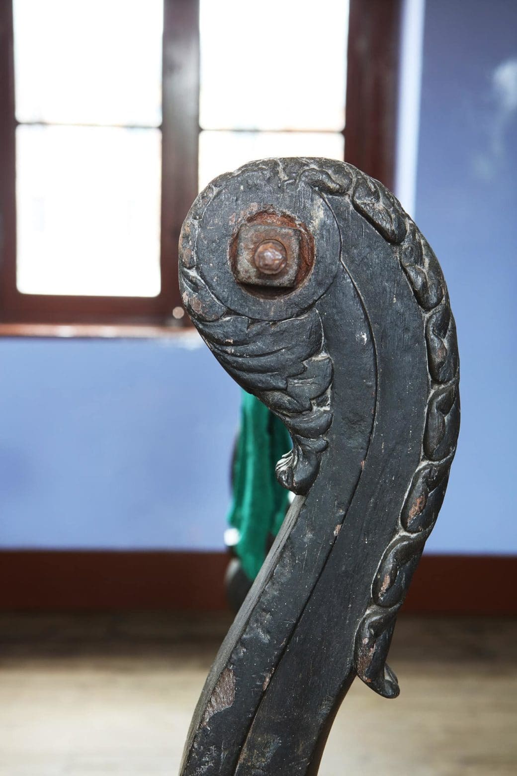 Close-up of carved scroll foot detail on 19th century Indian ebonised saddle rack stand from Collection EE10