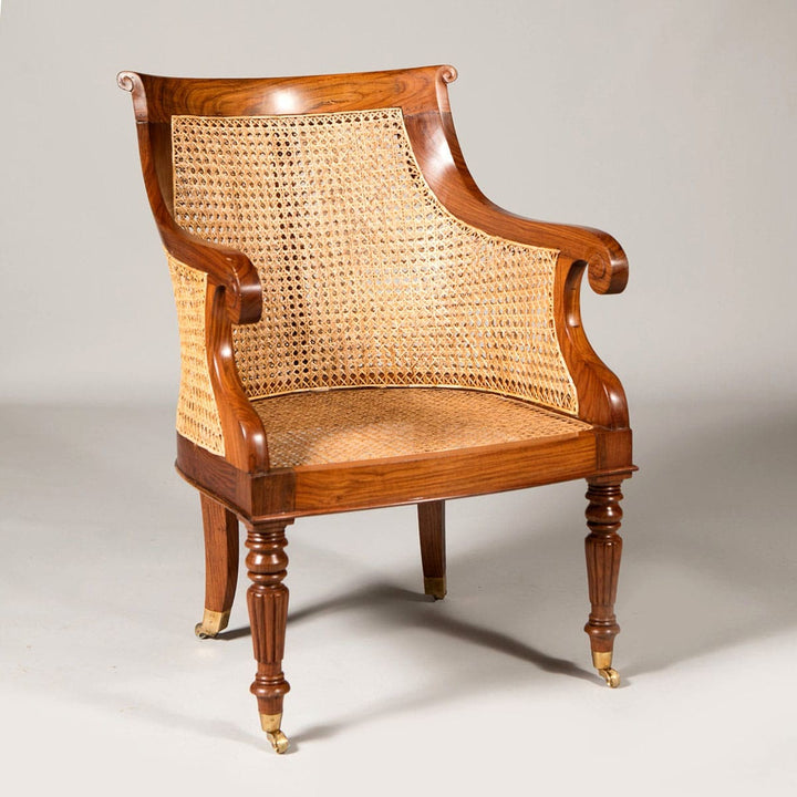 Regency style caned library chair with polished wood, brass castors, and hand-caned seat by Collection EE30