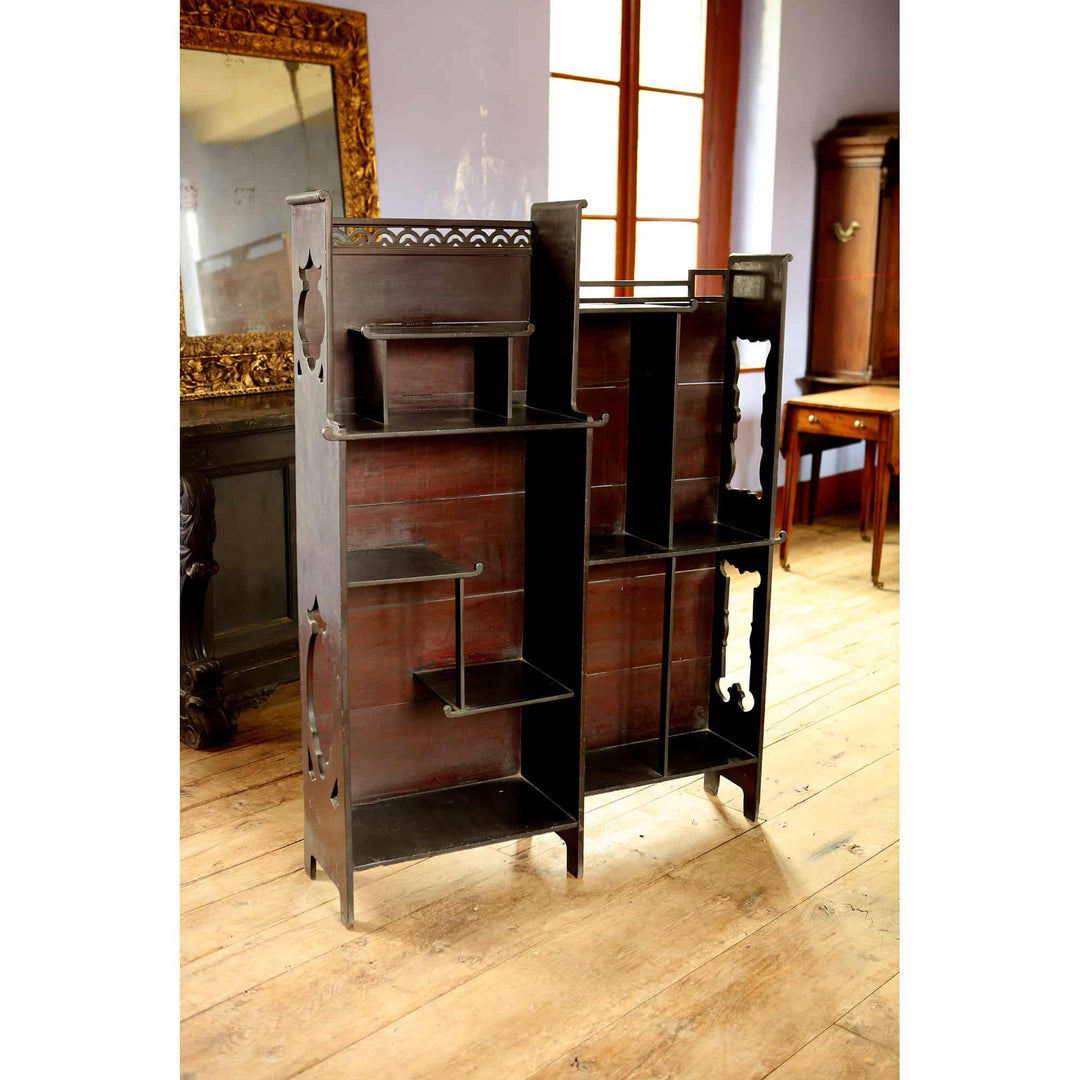 Japanese style open display shelves with intricate cut-out details by Collection EE40 in a bright vintage room