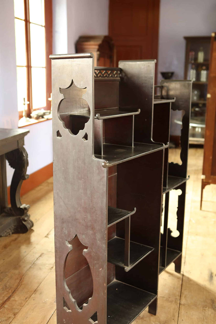 Japanese style open display shelves with intricate cutout design by Collection EE40 in a bright traditional room