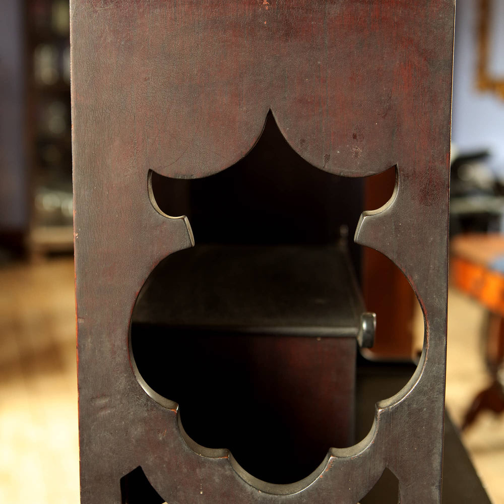Close-up of intricate carved detail on the Japanese style open display shelves by Collection EE40 showcasing lacquered wood finish