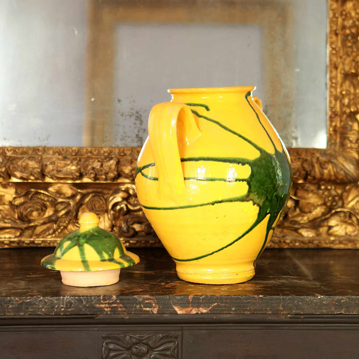 Canary yellow vase with green splash glaze and lid on wooden table by Collection EE20
