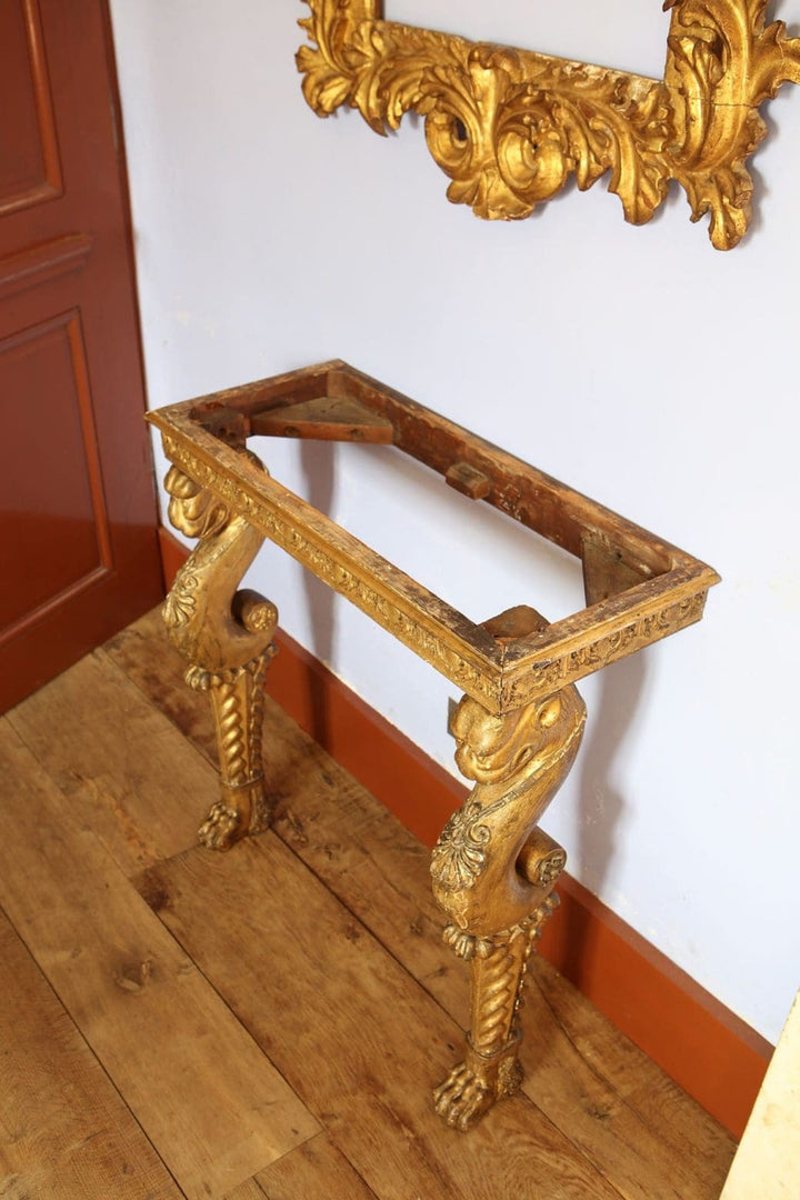 Regency Giltwood Console Table After the Antique with ornate gilt chimera legs and carved frieze in early 19th century style.