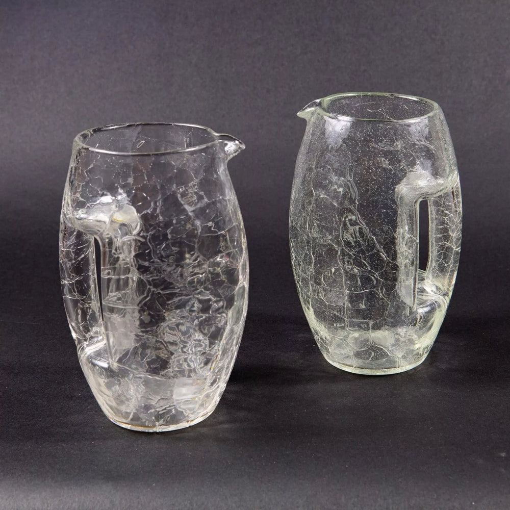 Pair of vintage Loetz crackle glass jugs with handles from Collection TH10 on dark background