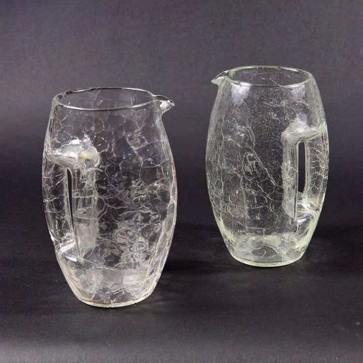 Pair of vintage Loetz crackle glass jugs with handles from Collection TH10 on dark background