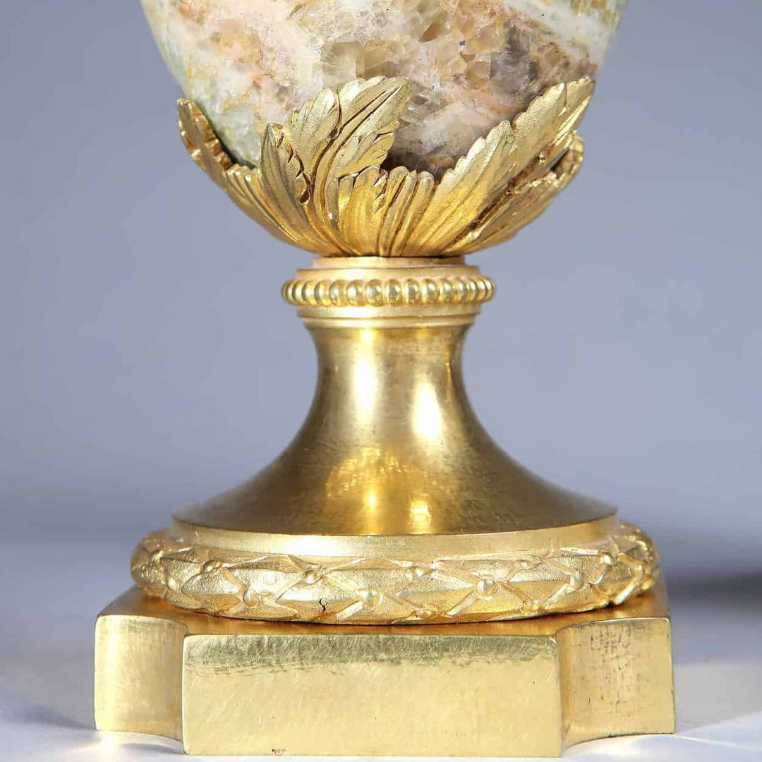 Close-up of gilt bronze base with ornate leaf and vine details on Weardale Fluorspar urn by Nwtiques