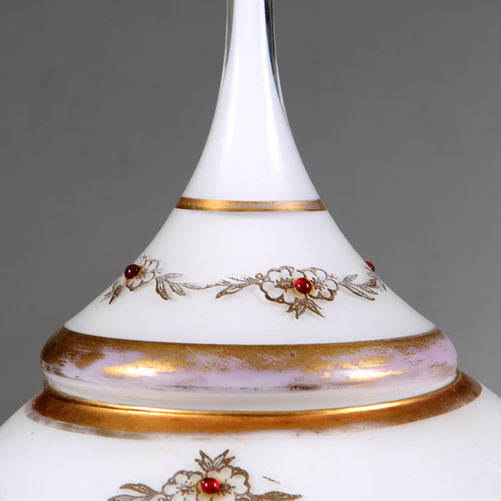 Close-up of a delicate opaline glass vase cover with gold trim and floral details by Collection TH10