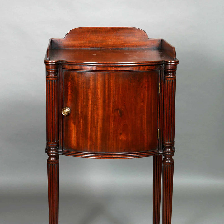 George III mahogany bedside cabinet with brass knob, fluted legs, and curved door by Collection CK20