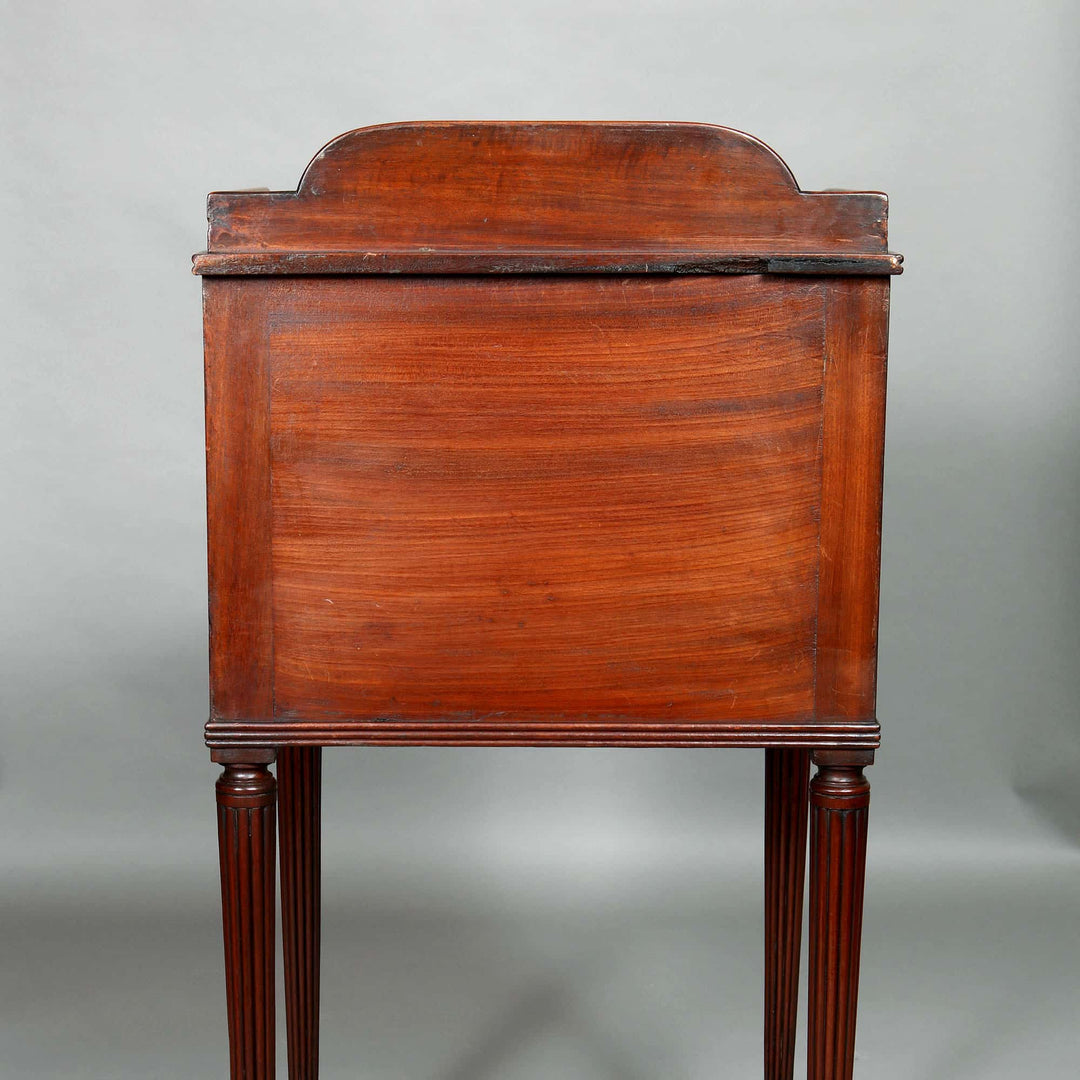 Side view of a George III mahogany bedside cabinet with fluted legs by Collection CK20