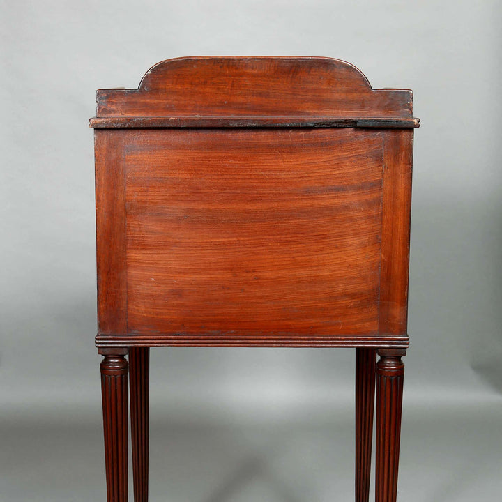 Side view of a George III mahogany bedside cabinet with fluted legs by Collection CK20