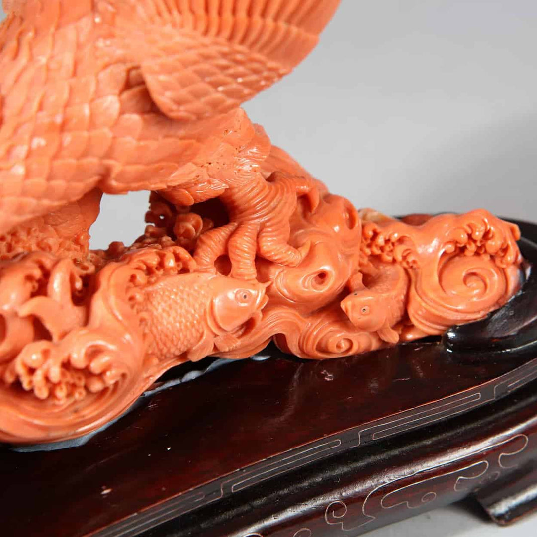 Close-up of a Japanese carved coral sculpture of an eagle catching a fish displayed by Nwtiques