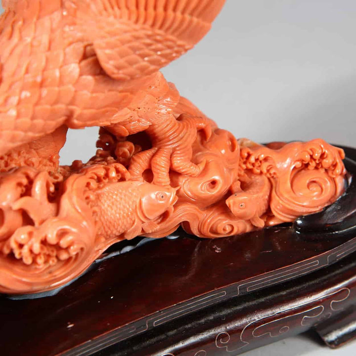 Close-up of a Japanese carved coral sculpture of an eagle catching a fish displayed by Nwtiques