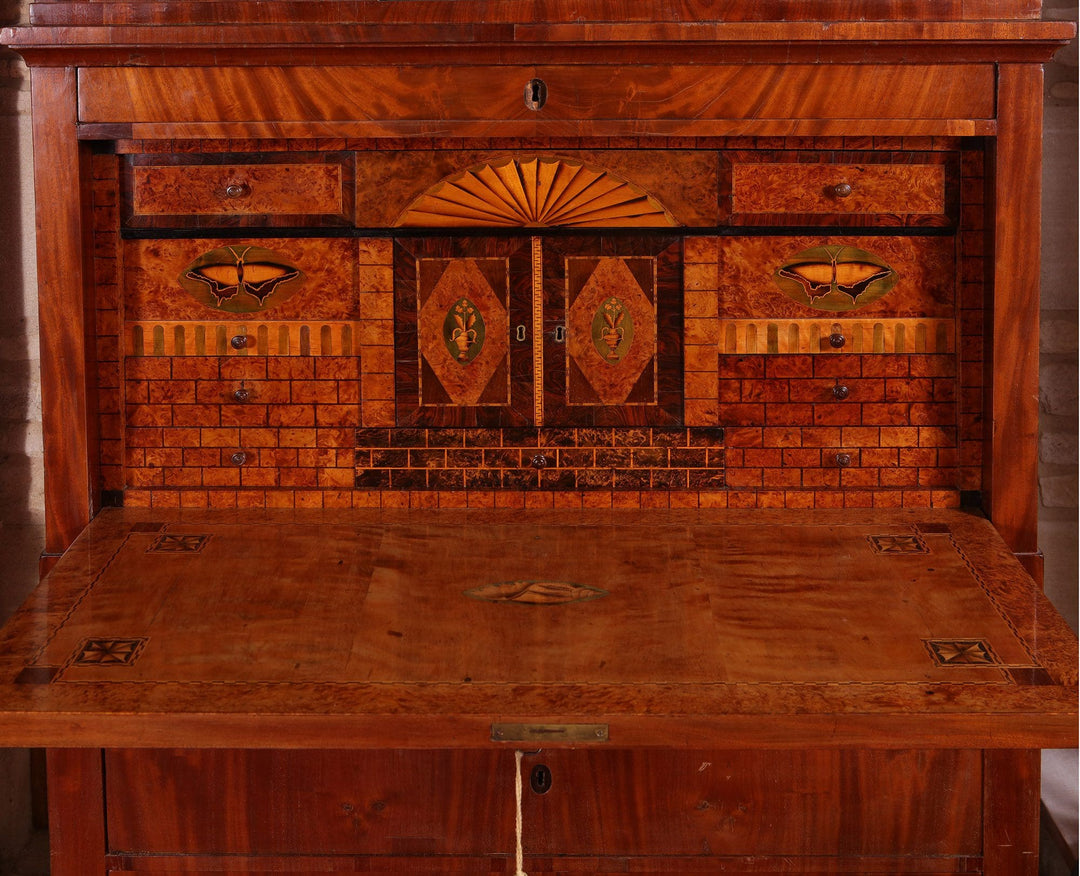 Biedermeier Secretaire abattant featuring flame mahogany veneers and intricate fitted interior with hidden drawers circa 1815.