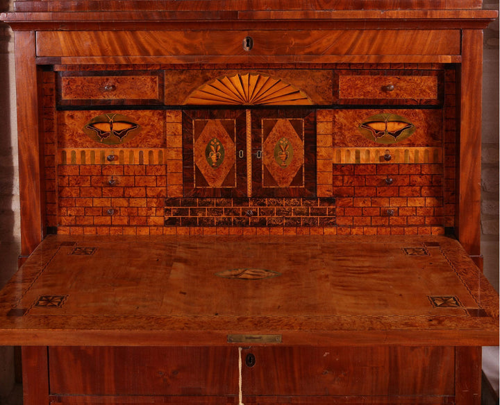 Biedermeier Secretaire abattant featuring flame mahogany veneers and intricate fitted interior with hidden drawers circa 1815.