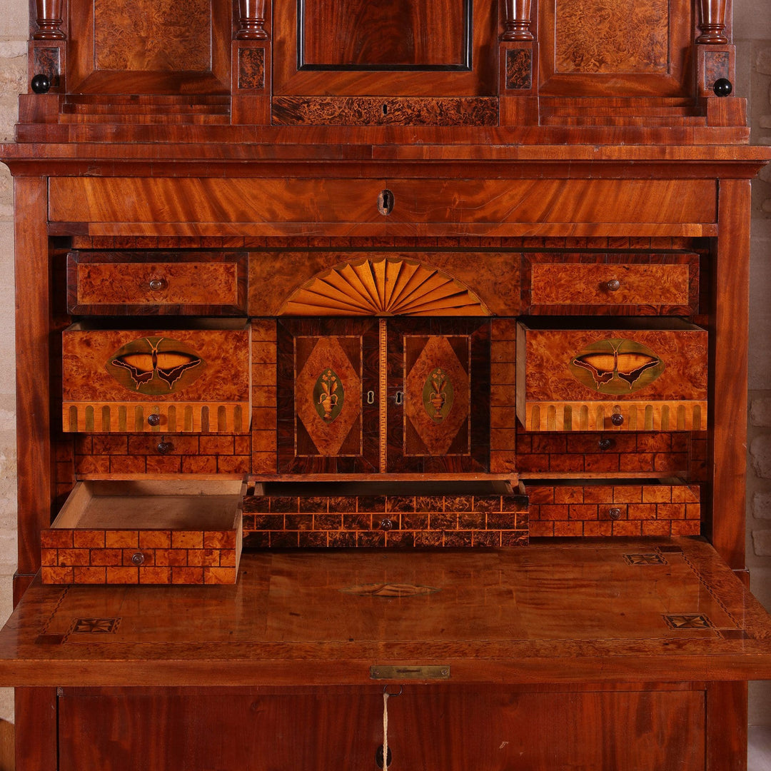 Biedermeier Secretaire abattant with flame mahogany veneers, fitted interior, hidden compartments, and three long drawers, circa 1815.