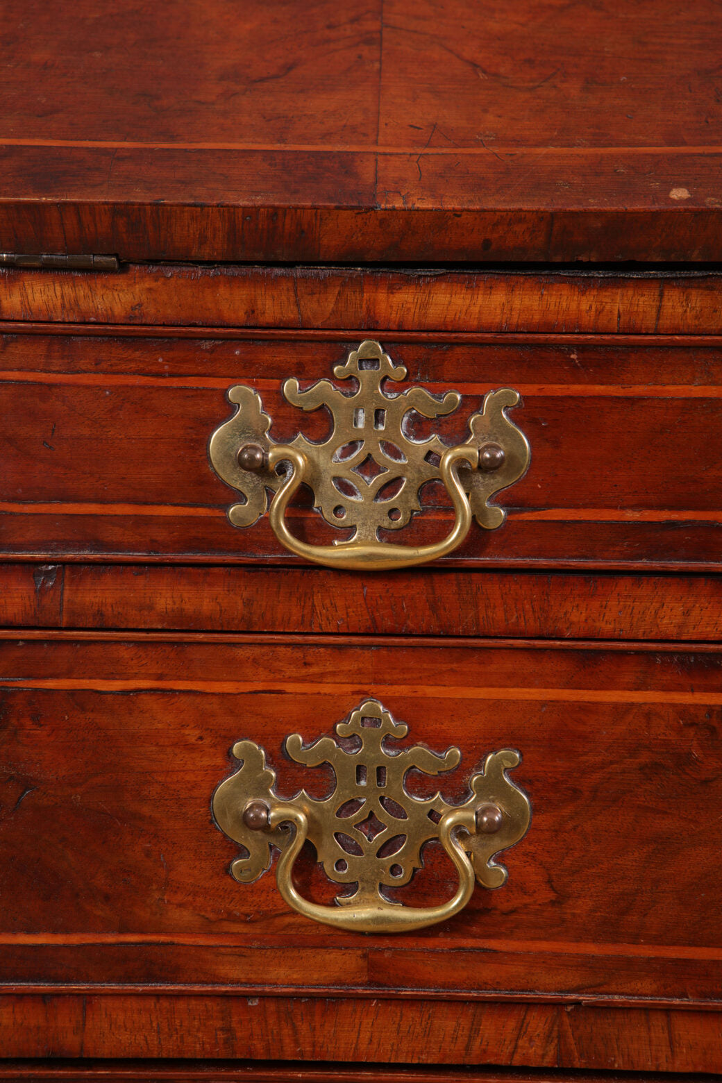 Early 18th Century Figured Walnut Bureau Cabinet showing brass handles on walnut drawers with rich wood grain detail.