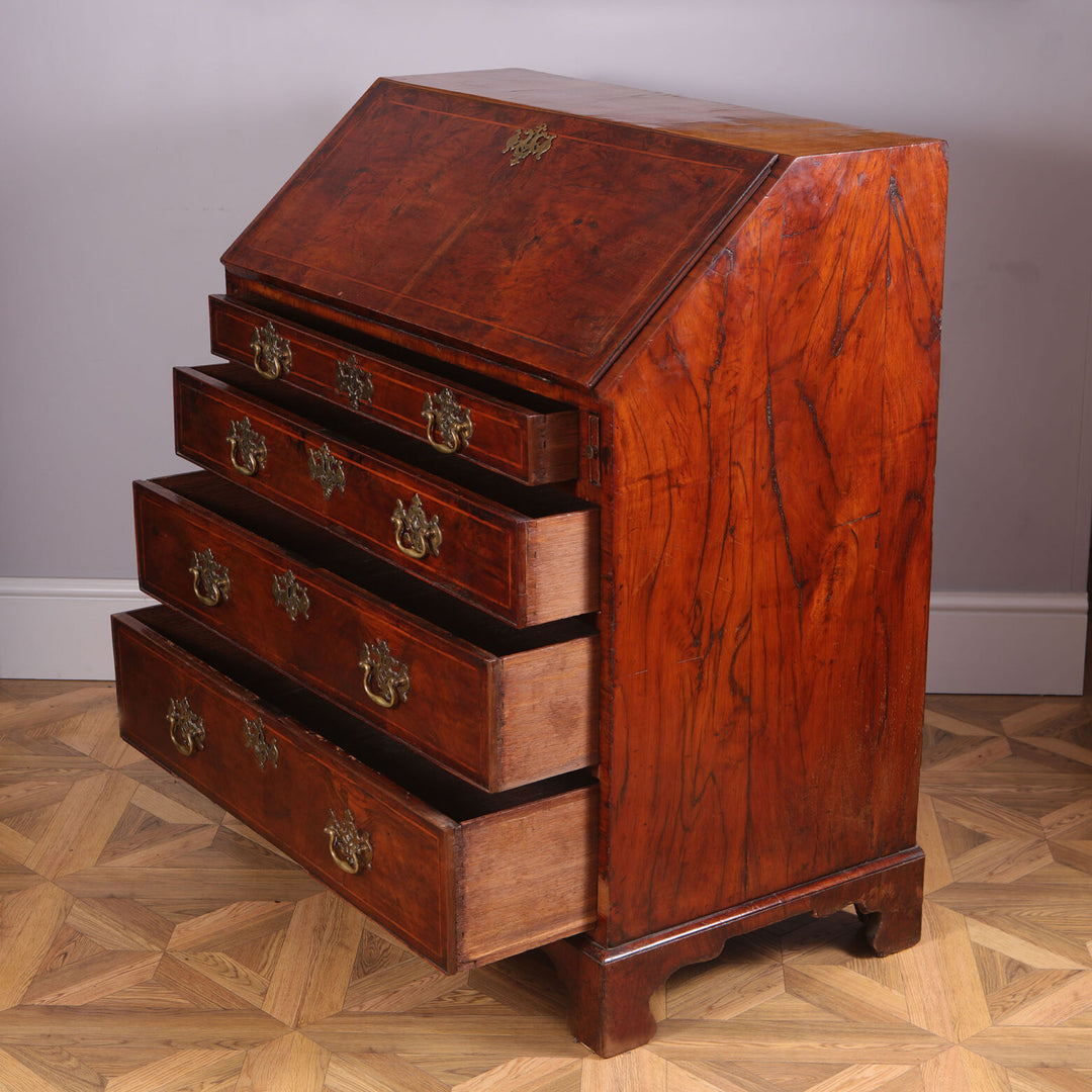 Early 18th Century Figured Walnut Bureau Cabinet with drop front and four drawers on bracket feet circa 1720 England.