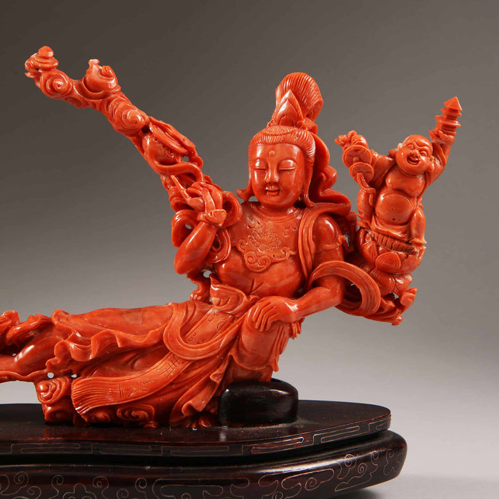 Chinese carved precious coral reclining Guanyin figure with attendants by Nwtiques circa 1900