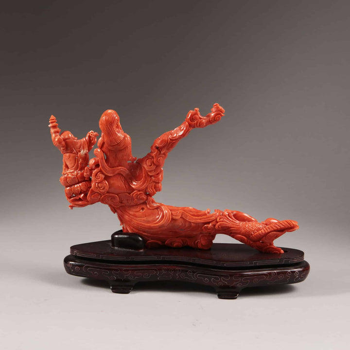 Chinese carved precious coral reclining Guanyin figure with attendants on carved wooden base by Nwtiques